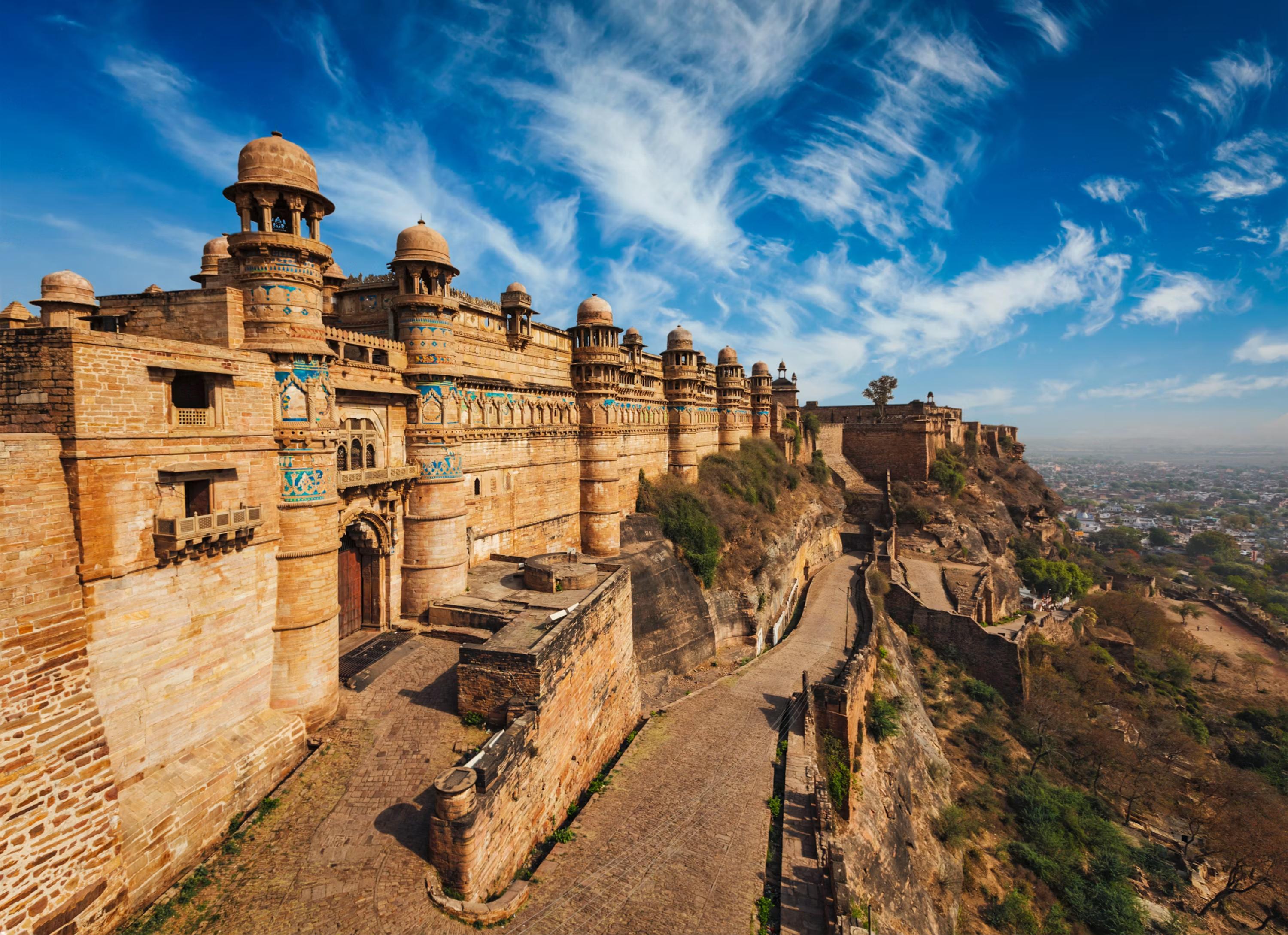 Tourist guides with visitors at Gwalior Fort under the Indian flag